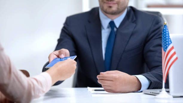 American consular officer giving passport to female immigrant, refugee visa 22698