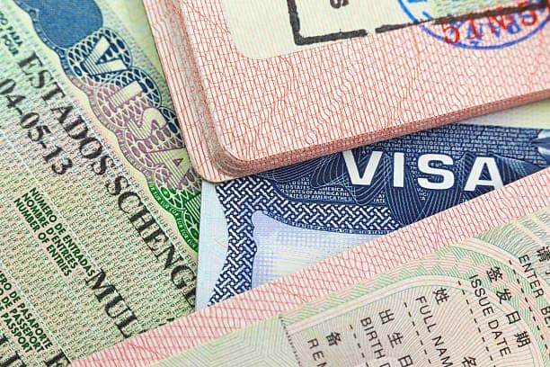 Chinese, USA and Shengen European visas in passports - adventure background 40675